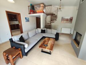 a living room with a couch and a coffee table at Villa Sotiriou in Limne