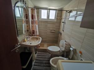 a small bathroom with a toilet and a sink at Villa Sotiriou in Límni +64 photos