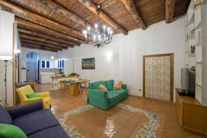 a living room with a blue couch and yellow chairs at Casa Ermelinda in Amalfi