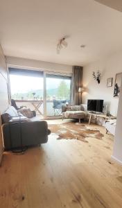 a living room with a couch and a tv at ALPartement Seefeld in Seefeld in Tirol