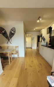 a living room with a table and a kitchen at ALPartement Seefeld in Seefeld in Tirol +18 photos