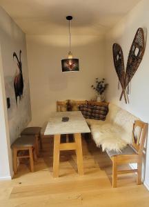 a living room with a table and a couch at ALPartement Seefeld in Seefeld in Tirol