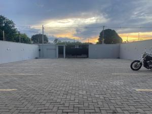 a motorcycle is parked in a parking lot at VivaVida Imperial 101 in Sinop