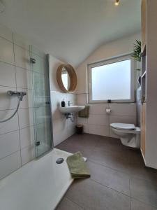 a bathroom with a shower and a toilet and a sink at Emstaler Auszeit in Bad Emstal +17 photos