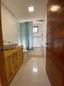 a bathroom with a sink and a toilet at Comfortable modular home in San Esteban