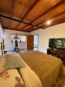 a bedroom with a bed and a flat screen tv at Comfortable modular home in San Esteban