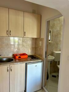 a kitchen with a sink and a counter top at Apartmani Vedrana Sutomore in Sutomore