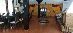 a dining room with two tables and chairs in a room at Casa Munteanu in Porumbacu de Sus