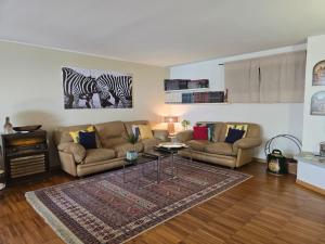 a living room with two couches and a rug at La BuCa - in Como - Elegant apartment, 150 sq m - Private covered parking - Private terrace - Just 1300 mt from downtown in Como