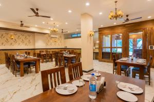 a dining room with wooden tables and chairs at The LAKE MOUNT in Udaipur
