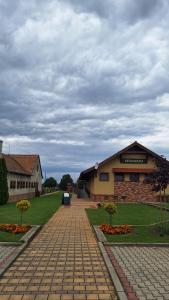 a brick road in front of a building at Penzión Petrov grunt in Košúty
