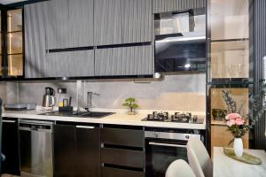 a kitchen with stainless steel appliances and a table at Villa L Olivia 2 in Belek