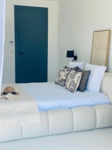 a white couch with pillows on it in a bedroom at Casa Mare e Macchia in Propriano