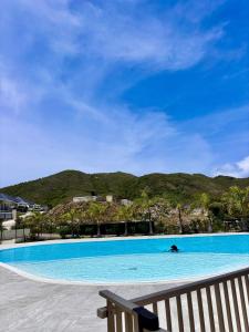 a large blue swimming pool next to a bench at Casa Soleil Vibrant Caribbean Hideaway, Perfect for families & friends in Cul de Sac