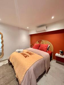 a bedroom with a large bed with red walls at Casa Soleil Vibrant Caribbean Hideaway, Perfect for families & friends in Cul de Sac +34 photos