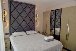a bedroom with a bed and a large mirror at Villa L Olivia 2 in Belek +19 photos