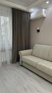 a living room with a couch and a window at Lux house in Bălţi