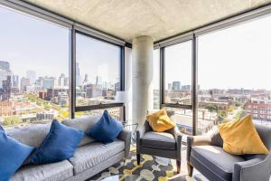 a living room with a couch and some windows at Bright & Modern 2BR Perfect City Escape in Chicago
