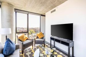 a living room with a large flat screen tv at Bright & Modern 2BR Perfect City Escape in Chicago