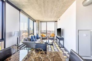 a living room with a couch and a table at Bright & Modern 2BR Perfect City Escape in Chicago
