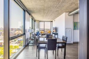 a dining room with a table and chairs and a couch at Bright & Modern 2BR Perfect City Escape in Chicago +30 photos