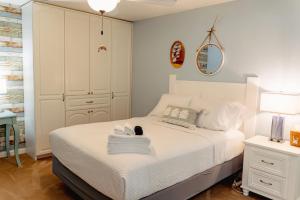 a bedroom with a bed with a towel on it at Jan's Oasis Family Retreat Pool Bar Games & Fun in Pensacola
