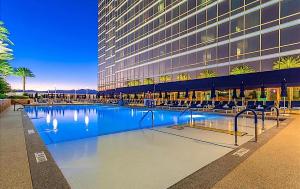 a large building with a swimming pool in front of a building at Trump Hotel Las Vegas Studio Strip Views in Las Vegas