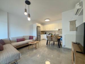a living room with a couch and a table at Asklepion Retreat in Kos