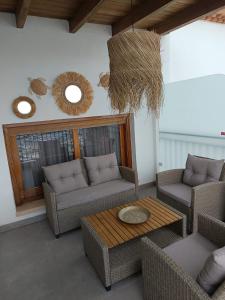 a living room with couches and a table and mirrors at Apartamento Balcón al Mediterráneo in Moraira