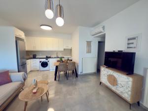 a living room with a couch and a dining room at Asklepion Retreat in Kos +16 photos