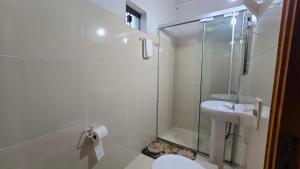 a bathroom with a shower and a toilet and a sink at Rd hotel in Colonia Felicidad +44 photos