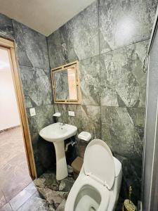 a bathroom with a toilet and a sink at Dulce & Guanábana suite House in Canoa +13 photos