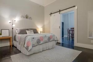 a bedroom with a bed and a table and a door at Riverside Hideaway just outside of downtown Cincy in Cincinnati
