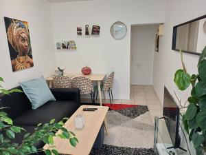 a living room with a couch and a table at La clef des cœurs in Montargis
