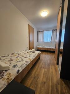 a small bedroom with a bed and a window at Vacation home Vilim in Kamešnica
