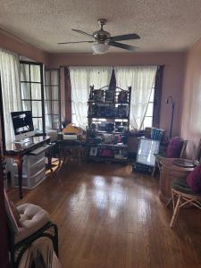a living room filled with furniture and a ceiling fan at Historic Retreat in Detroit