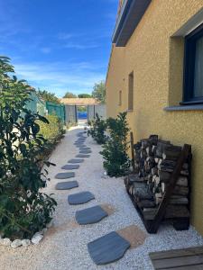 a garden with stepping stones next to a building at Etoile du Matin avec Piscine Zen Privative in Margon