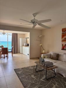 a living room with a couch and a table at Grand Case Beachfront Apartment in Grand Case