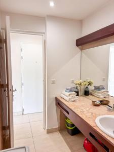 a bathroom with a sink and a mirror at Grand Case Beachfront Apartment, Perfect for a couple looking a romantic Gateway in Grand Case +39 photos