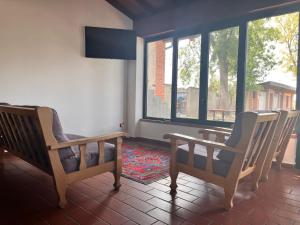 a room with two chairs and a table and windows at Il Cortile Agriturismo in Borgonovo Val Tidone