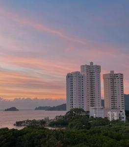 a group of tall buildings in front of the water at Apartamento Santa Marta Reserva del Mar 530 in Gaira