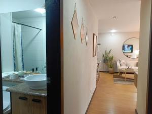 a bathroom with a sink and a living room at Apartment - 2Bedrooms - QueenBed - Balcony - Parking - 7thFLOOR in Quito +37 photos