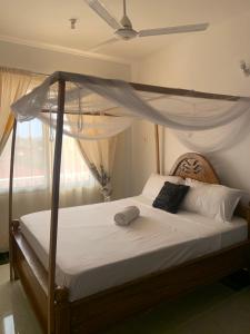Cama ou camas em um quarto em Kivutio cha pwani
