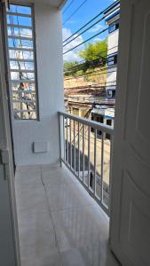 a room with a balcony with a view of a building at Apartasuite en Cartago in Cartago