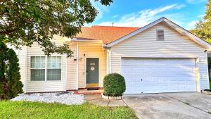a white house with a garage at Christmas 3BR , King and Queen Beds , Uptown Charlotte in Charlotte