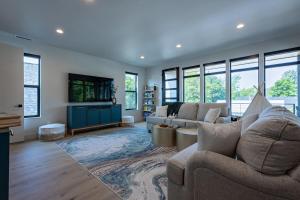 a living room with two couches and a tv at Downtown Luxury Villa Hot Tub Walk To Lake in Coeur d'Alene
