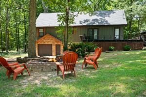 a group of chairs around a fire pit in front of a house at Kentucky Lake Retreat in Dover