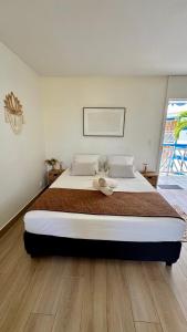 a bedroom with a large bed in a room at L'Escale - vue mer avec cuve in Saint-François