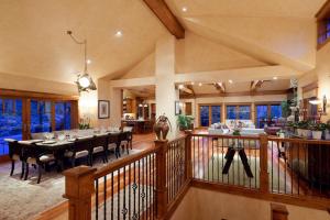 a dining room and living room with a table and chairs at Luxe Artful Mountain Retreat with 4 King Suites, 8 Person Hot Tub and 3 Decks in Carbondale