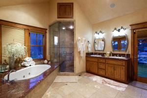 a large bathroom with a tub and a shower at Luxe Artful Mountain Retreat with 4 King Suites, 8 Person Hot Tub and 3 Decks in Carbondale +54 photos